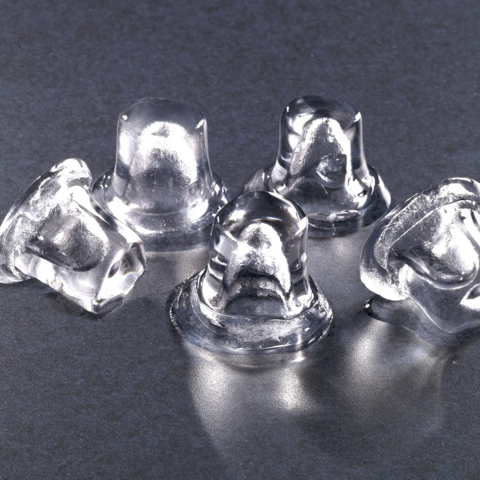 Hoshizaki AM-50BAJ ice cubes on a dark surface, showing top hat shape.