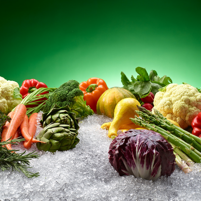 Variety of fresh vegetables displayed on flaked ice from a Hoshizaki F-1501MAJ icemaker.