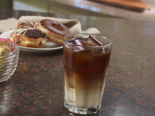 Glass of iced coffee with crescent-shaped ice cubes.